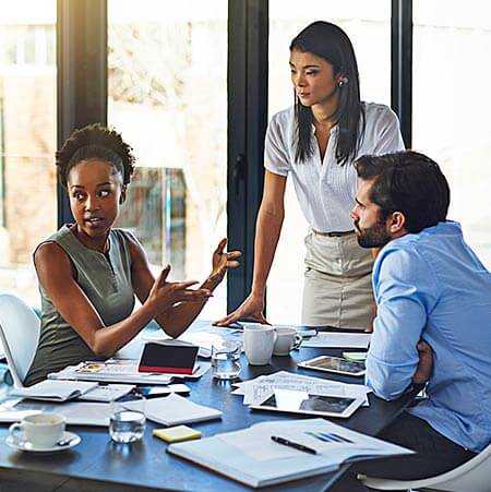 Three business professionals at a meeting